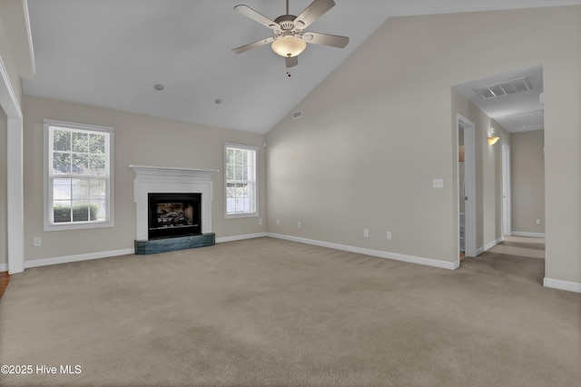 unfurnished living room with ceiling fan, carpet floors, a fireplace with raised hearth, baseboards, and visible vents