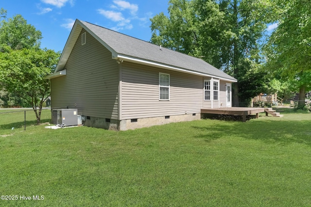 back of property with crawl space, a wooden deck, central AC, fence, and a yard