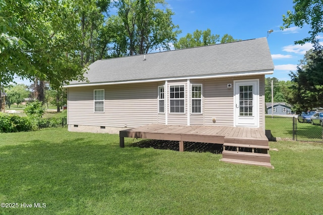 rear view of property featuring fence, a yard, a deck, and crawl space