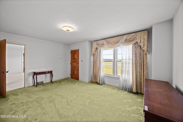 carpeted spare room with baseboards and visible vents