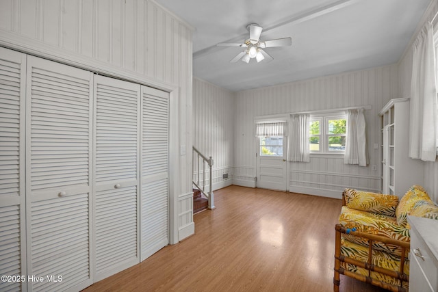 living area featuring a ceiling fan and light wood-type flooring