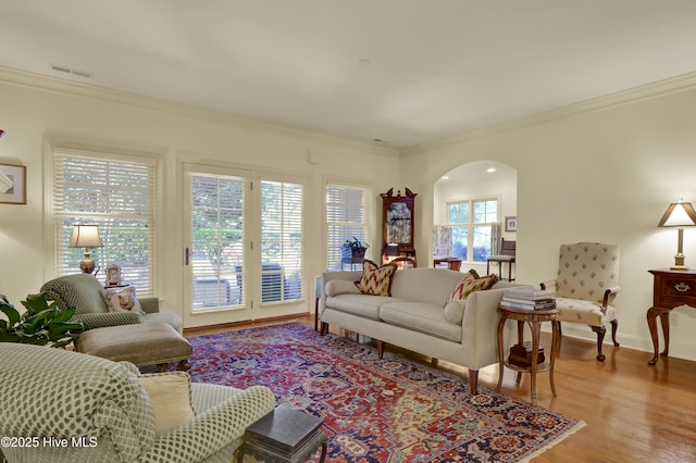 7102 Saybrook Dr, Wilmington, NC 28405 - living area with arched walkways, crown molding, wood finished floors, and baseboards