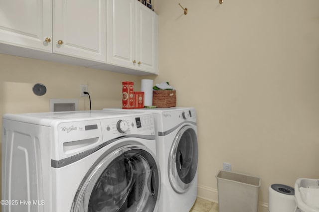 7102 Saybrook Dr, Wilmington, NC 28405 - washroom with cabinet space, washing machine and clothes dryer, light tile patterned flooring, and baseboards