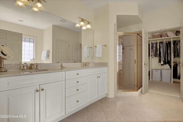 7102 Saybrook Dr, Wilmington, NC 28405 - full bathroom featuring tile patterned flooring, a stall shower, double vanity, and a spacious closet