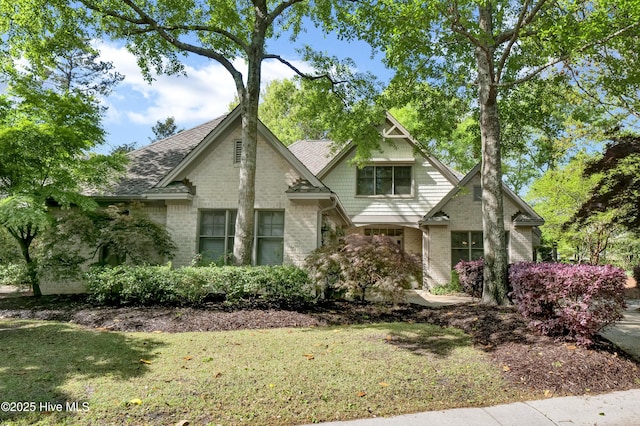 7102 Saybrook Dr, Wilmington, NC 28405 - tudor house with brick siding and a front lawn