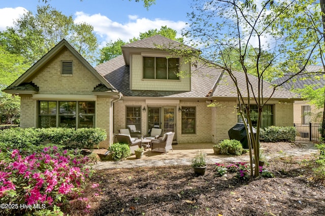 7102 Saybrook Dr, Wilmington, NC 28405 - back of property with brick siding, a shingled roof, a patio area, and fence