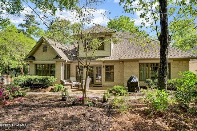 7102 Saybrook Dr, Wilmington, NC 28405 - back of property with brick siding, a shingled roof, a patio area, and fence
