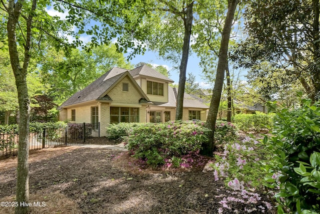 7102 Saybrook Dr, Wilmington, NC 28405 - view of front of home featuring fence, brick siding, and a shingled roof