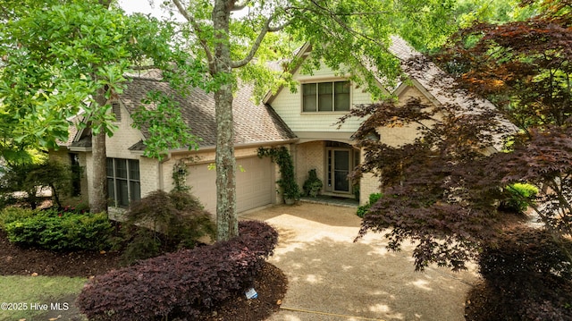 7102 Saybrook Dr, Wilmington, NC 28405 - view of front of house featuring a shingled roof, concrete driveway, brick siding, and an attached garage