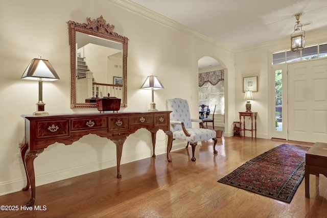 7102 Saybrook Dr, Wilmington, NC 28405 - entryway featuring arched walkways, wood finished floors, baseboards, and ornamental molding