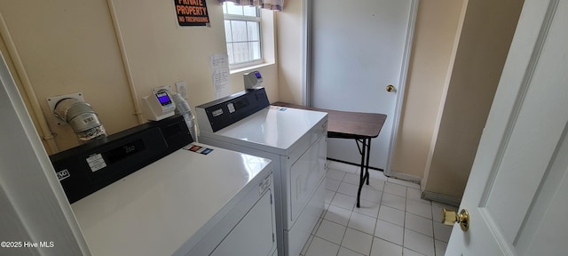 laundry area with washer and dryer, laundry area, and light tile patterned floors