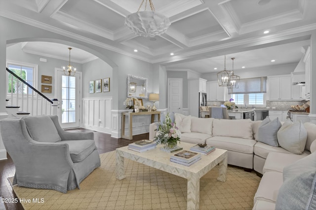 6221 Chalfont Cir, Wilmington, NC 28405 - living area with arched walkways, a chandelier, a wealth of natural light, and coffered ceiling