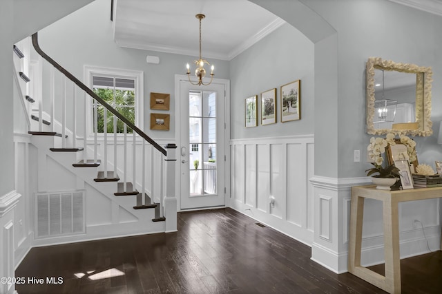 6221 Chalfont Cir, Wilmington, NC 28405 - entryway featuring dark wood-style flooring, a decorative wall, arched walkways, stairs, and visible vents