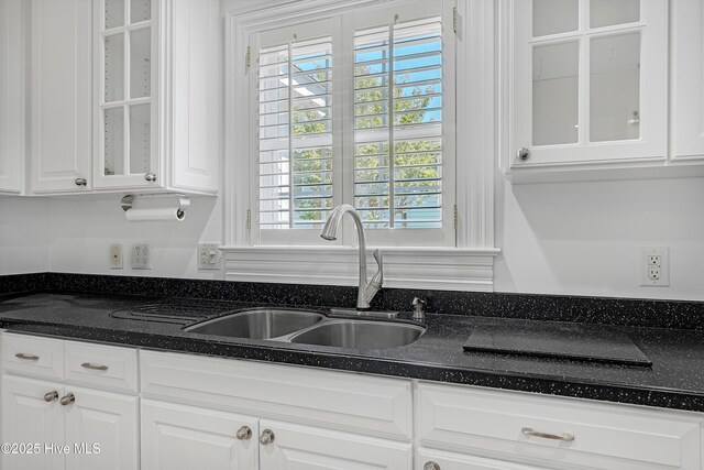 114 N Atlantic Ave, Southport, NC 28461 - kitchen featuring a sink, white cabinets, glass insert cabinets, and dark stone countertops