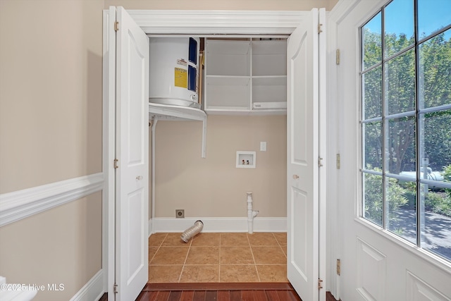 114 N Atlantic Ave, Southport, NC 28461 - laundry area featuring washer hookup, hookup for an electric dryer, plenty of natural light, and dark tile patterned flooring
