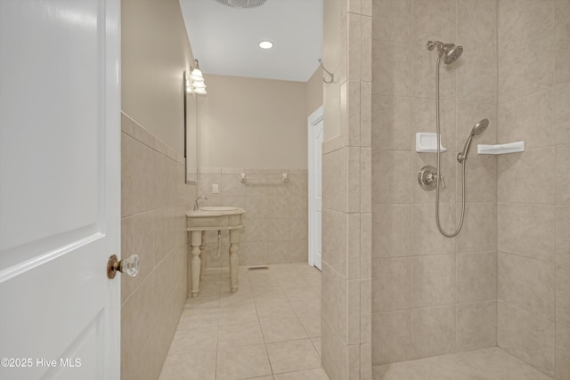 114 N Atlantic Ave, Southport, NC 28461 - full bathroom with a tile shower, tile walls, wainscoting, and tile patterned flooring