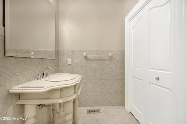 114 N Atlantic Ave, Southport, NC 28461 - bathroom with a sink, tile walls, and tile patterned floors