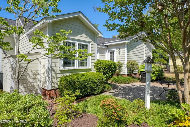 114 N Atlantic Ave, Southport, NC 28461 - view of front of house with a patio and a shingled roof