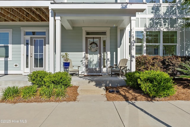 view of exterior entry with covered porch