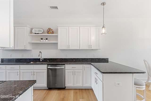 kitchen with visible vents, open shelves, dishwasher, a sink, and a peninsula