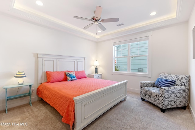 bedroom featuring visible vents, baseboards, recessed lighting, a tray ceiling, and carpet