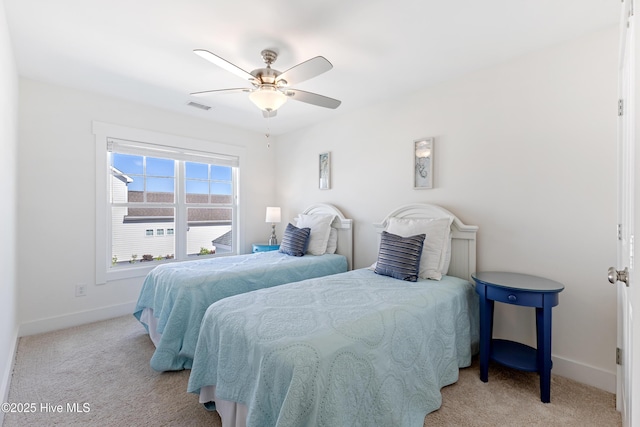 carpeted bedroom featuring baseboards, ceiling fan, and visible vents