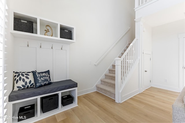 mudroom with baseboards and wood finished floors