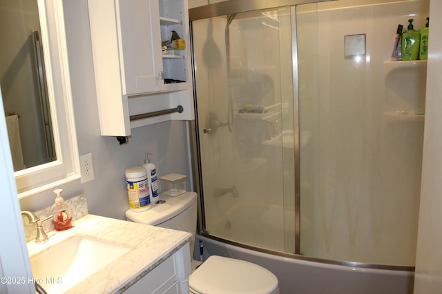bathroom featuring shower / bath combination with glass door, toilet, and vanity