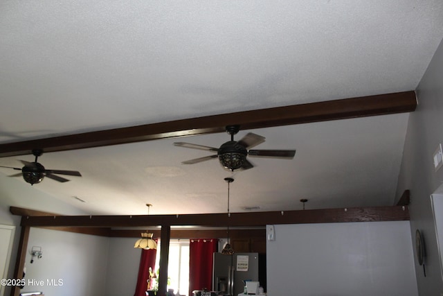 interior details featuring ceiling fan, stainless steel fridge, and beam ceiling