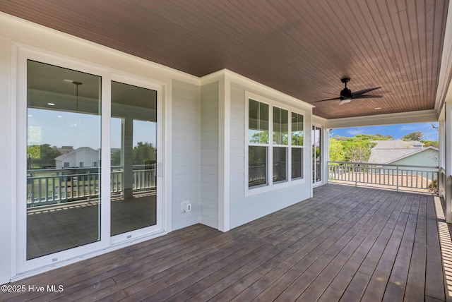 110 SW 26th St, Oak Island, NC 28465 - wooden deck with a ceiling fan