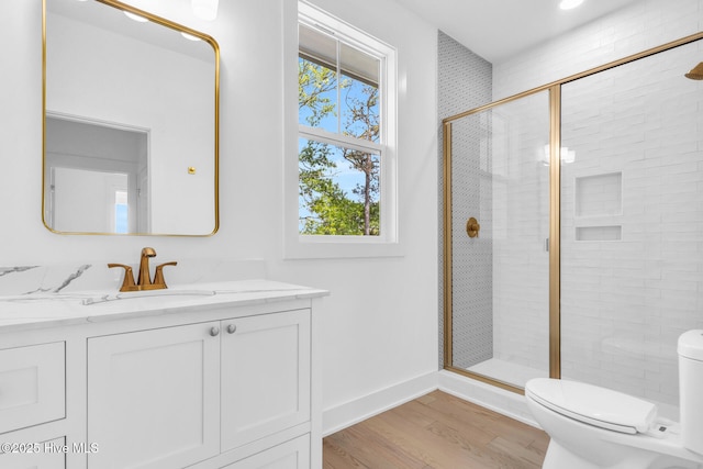 110 SW 26th St, Oak Island, NC 28465 - bathroom with wood finished floors, a wealth of natural light, toilet, and a shower stall