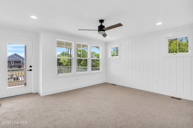 110 SW 26th St, Oak Island, NC 28465 - carpeted spare room featuring visible vents, a ceiling fan, a healthy amount of sunlight, and recessed lighting