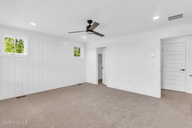 110 SW 26th St, Oak Island, NC 28465 - unfurnished bedroom with multiple windows, carpet flooring, and visible vents