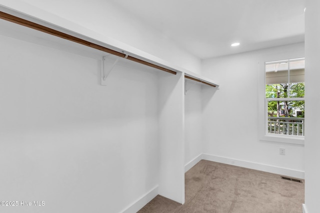 110 SW 26th St, Oak Island, NC 28465 - spacious closet featuring carpet flooring and visible vents