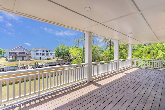 110 SW 26th St, Oak Island, NC 28465 - wooden deck featuring a yard