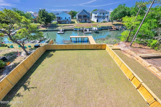 110 SW 26th St, Oak Island, NC 28465 - dock area with a fenced backyard, a water view, and a lawn