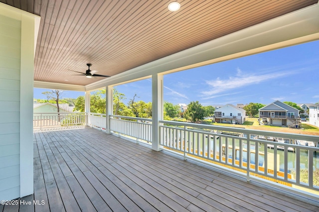 110 SW 26th St, Oak Island, NC 28465 - deck with a water view, ceiling fan, and a residential view