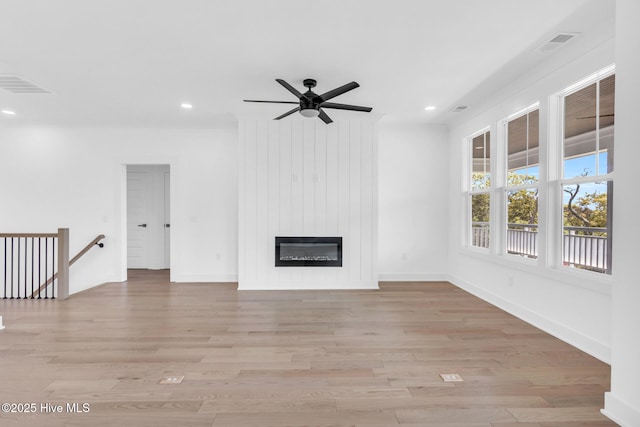 110 SW 26th St, Oak Island, NC 28465 - unfurnished living room with light wood finished floors, recessed lighting, and visible vents
