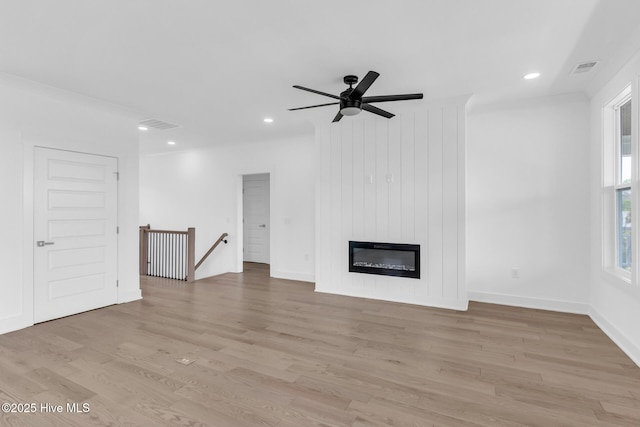 110 SW 26th St, Oak Island, NC 28465 - unfurnished living room with recessed lighting, light wood-style flooring, and ceiling fan