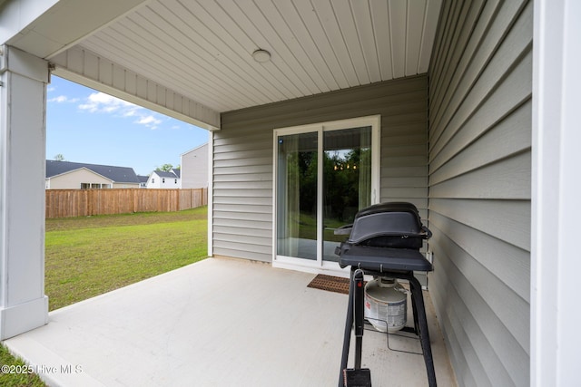 view of patio with a grill and fence