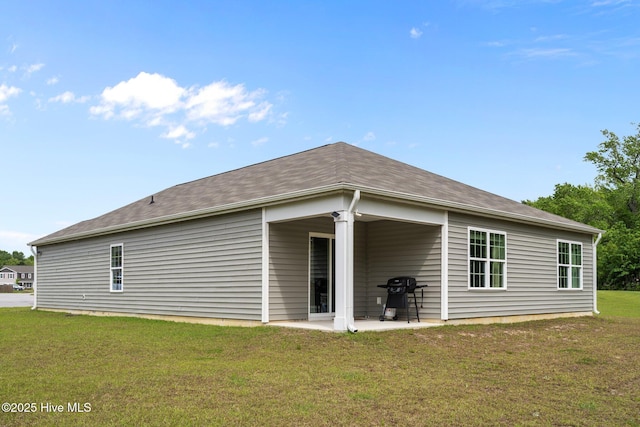 back of house featuring a lawn and a patio