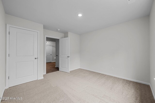 1157 Carteret Manor Dr, Jacksonville, NC 28546 - unfurnished bedroom with carpet flooring, baseboards, and recessed lighting