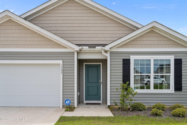 ranch-style house with concrete driveway and an attached garage