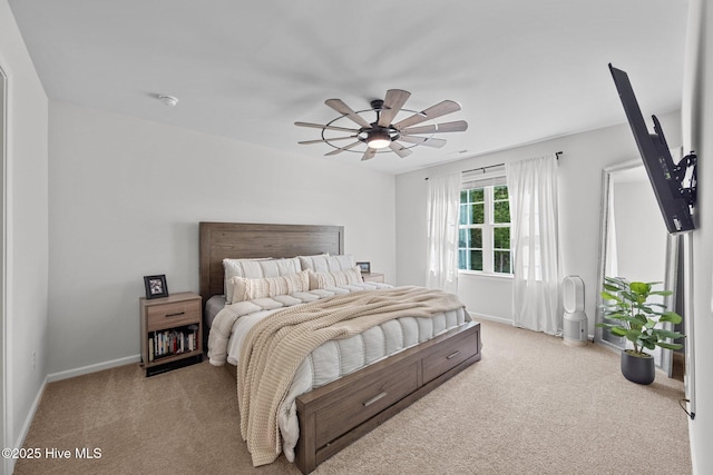 bedroom with a ceiling fan, carpet flooring, and baseboards