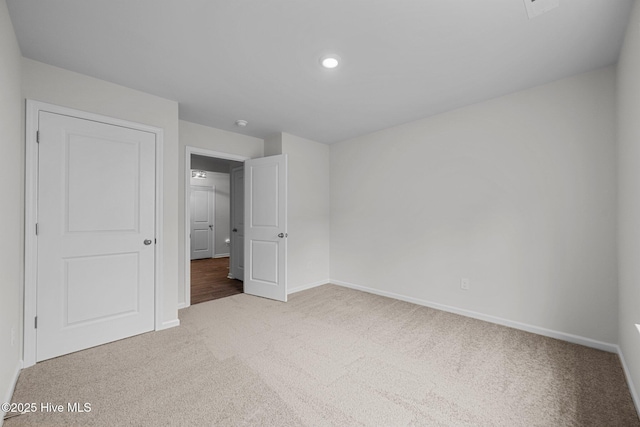 unfurnished bedroom with baseboards, recessed lighting, and carpet floors