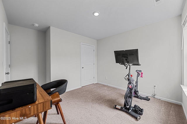exercise area featuring baseboards, visible vents, and carpet floors