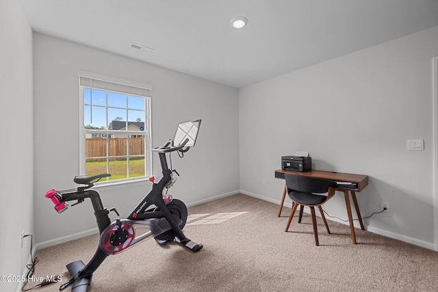 workout room with baseboards, visible vents, and carpet