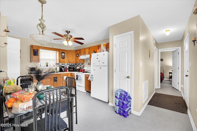 1202 S 8th St, Wilmington, NC 28401 - kitchen featuring a ceiling fan, visible vents, brown cabinets, under cabinet range hood, and white appliances