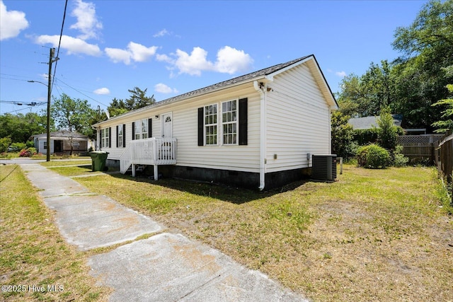 1202 S 8th St, Wilmington, NC 28401 - manufactured / mobile home with crawl space, fence, central AC unit, and a front yard