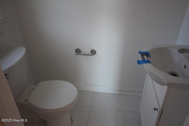 bathroom featuring vanity, tile patterned flooring, and toilet